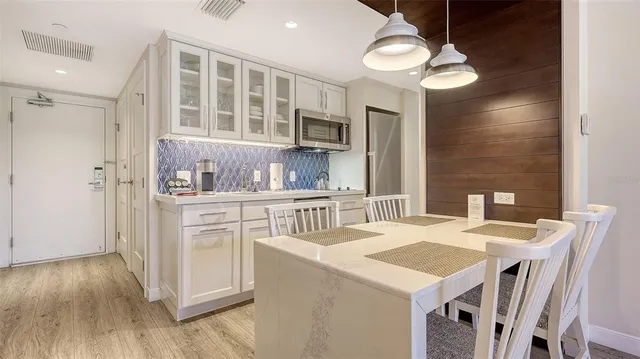 a kitchen that has a table and chairs in it