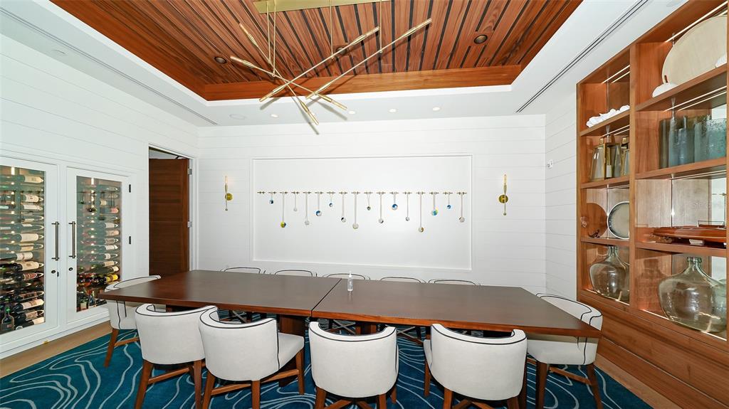 250 Sands Point Road, Unit 5101 Longboat Key, FL 34228 - Photo 35 of 42 a dining room with furniture and wooden floor