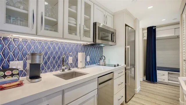 a kitchen with a sink and a microwave