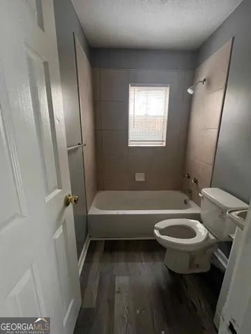 a bathroom with a sink a toilet and a bathtub