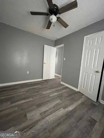 a view of an empty room and wooden floor