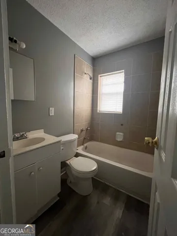 a bathroom with a sink a toilet and bathtub