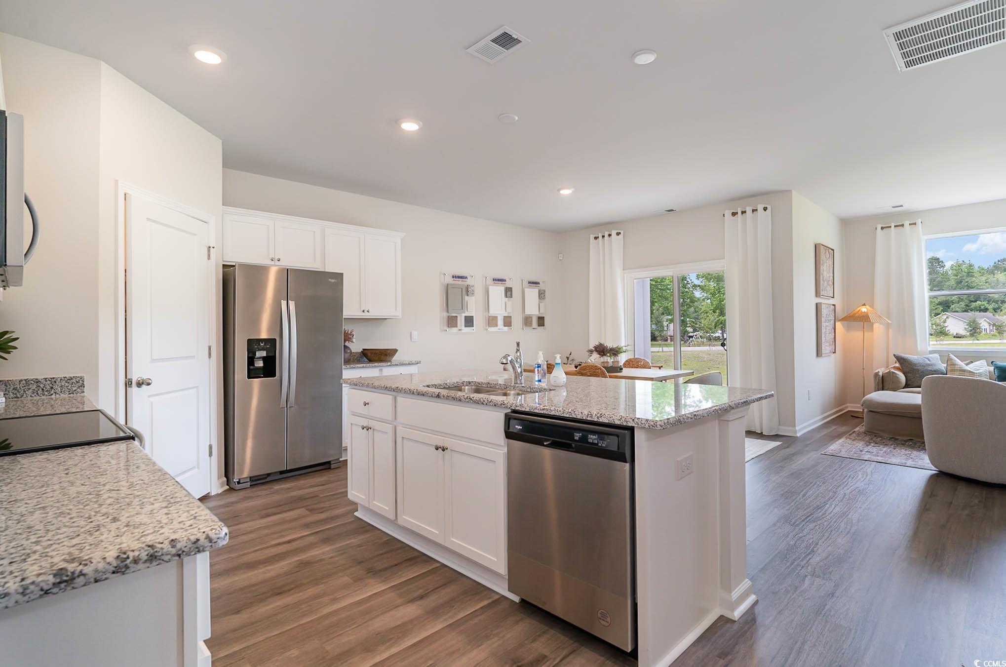 111 Cassina Drive Longs, SC 29568 - Photo 11 of 25 Kitchen featuring a center island with sink, hardw