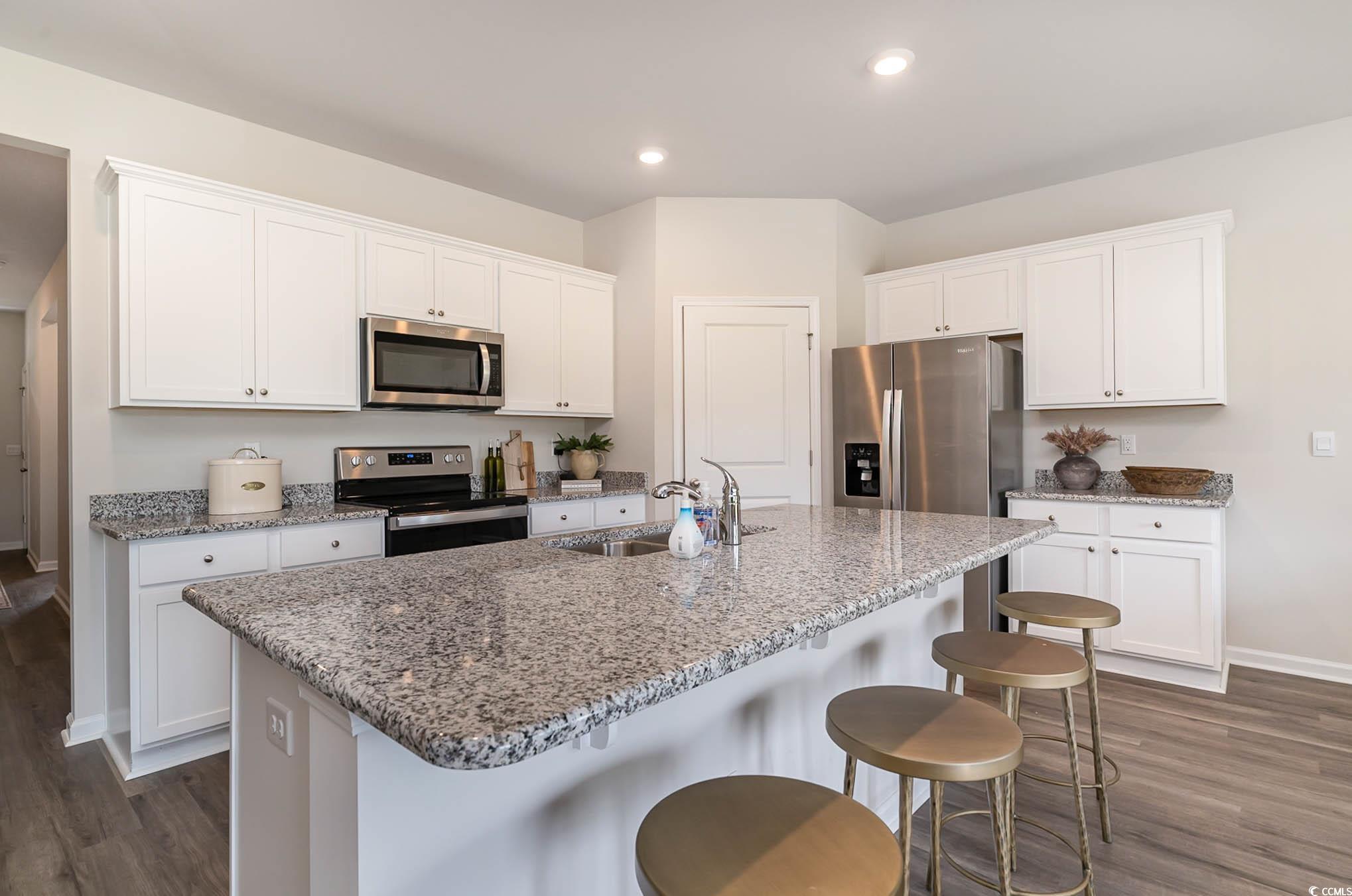 111 Cassina Drive Longs, SC 29568 - Photo 12 of 25 Kitchen with dark wood-type flooring, an island wi