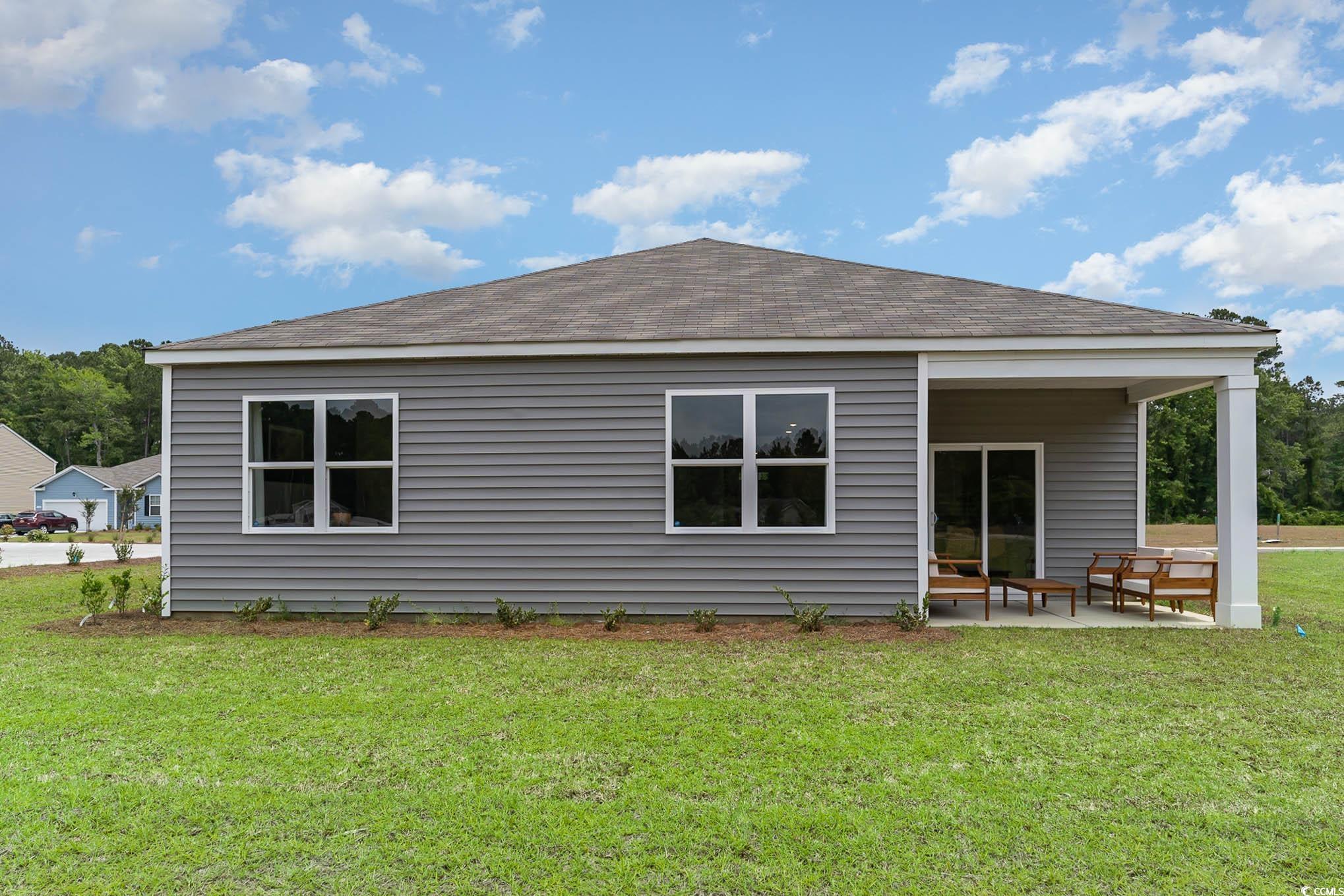 111 Cassina Drive Longs, SC 29568 - Photo 2 of 25 Back of house featuring a patio and a lawn