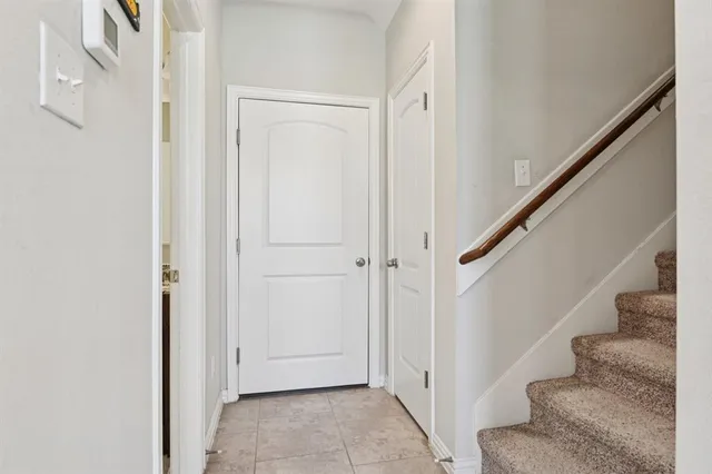a view of entryway with white walls and stairs