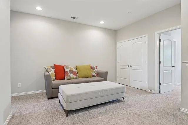 a spacious bedroom with a bed and a night stand