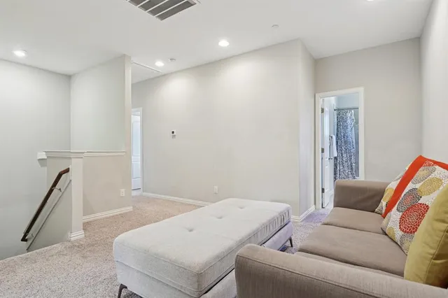 a living room with furniture and a rug