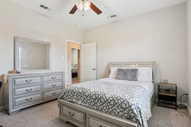 a bedroom with a large bed and a dresser