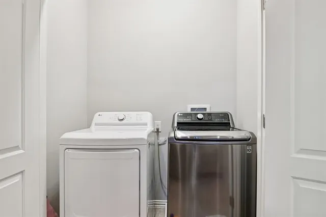 a view of storage and utility room with washer and dryer