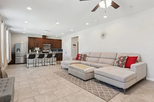 a living room with furniture and kitchen view