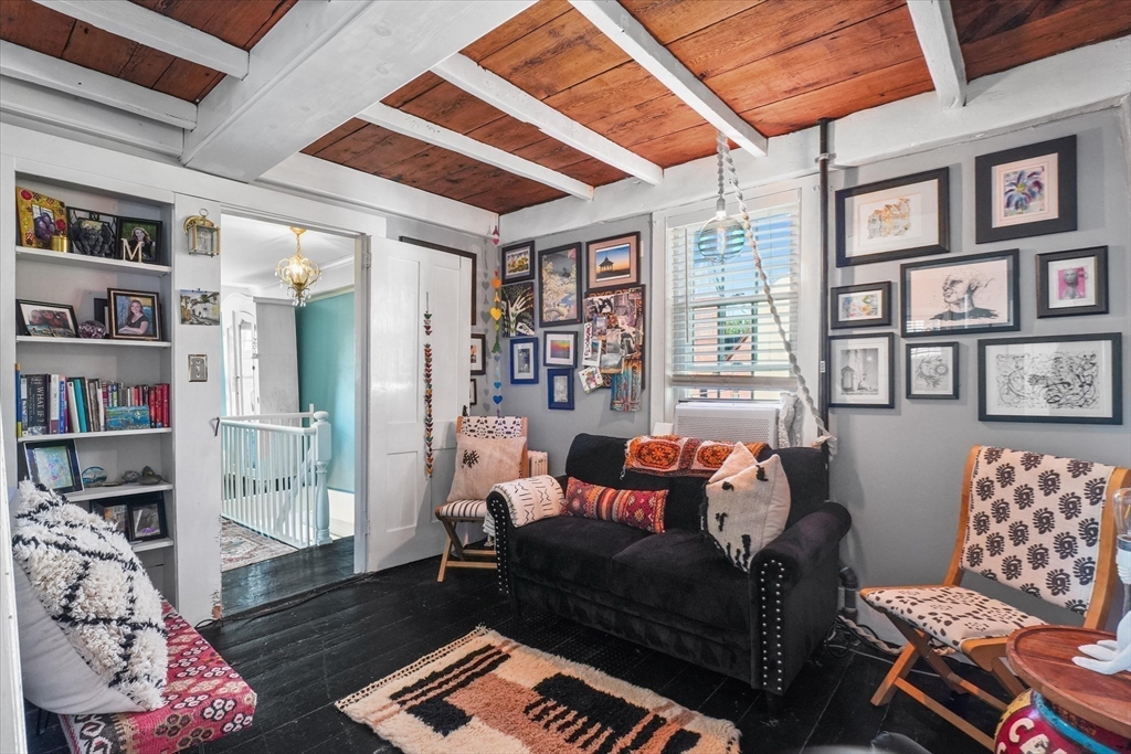 434 Main Street Amesbury, MA 01913 - Photo 13 of 40 a living room with furniture and a book shelf