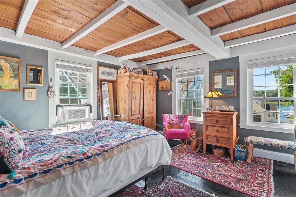 434 Main Street Amesbury, MA 01913 - Photo 16 of 40 a bedroom with a bed next to a window with outer view