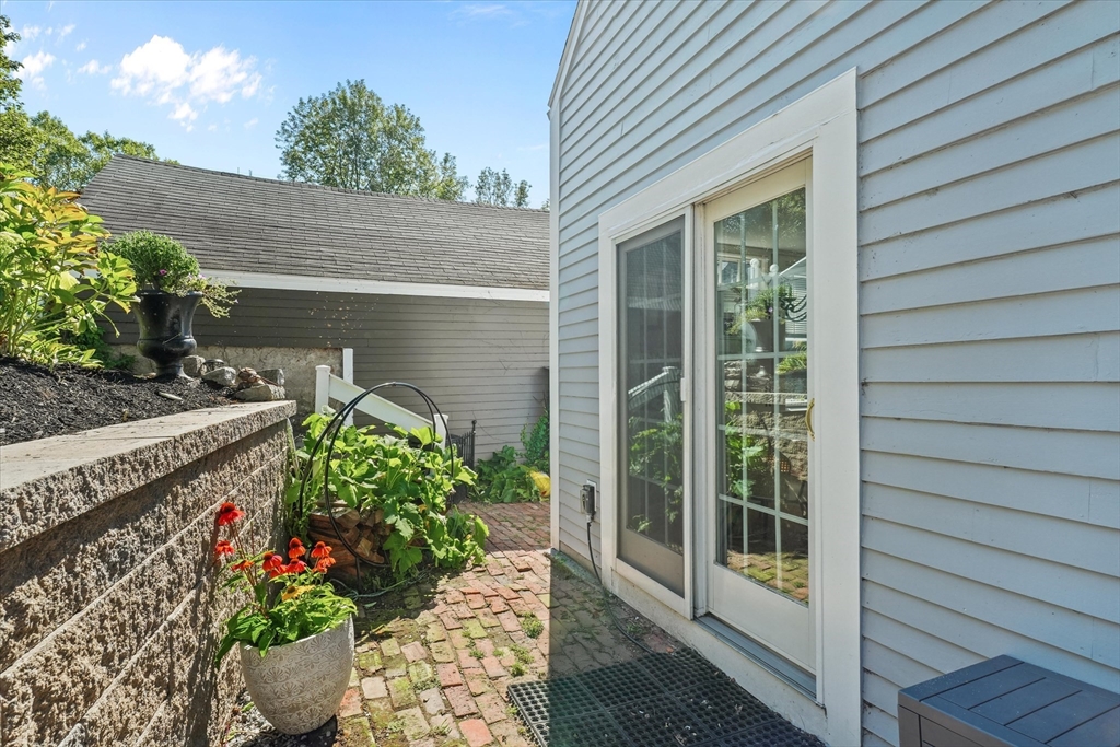 434 Main Street Amesbury, MA 01913 - Photo 25 of 40 a potted plant sitting in front of a house