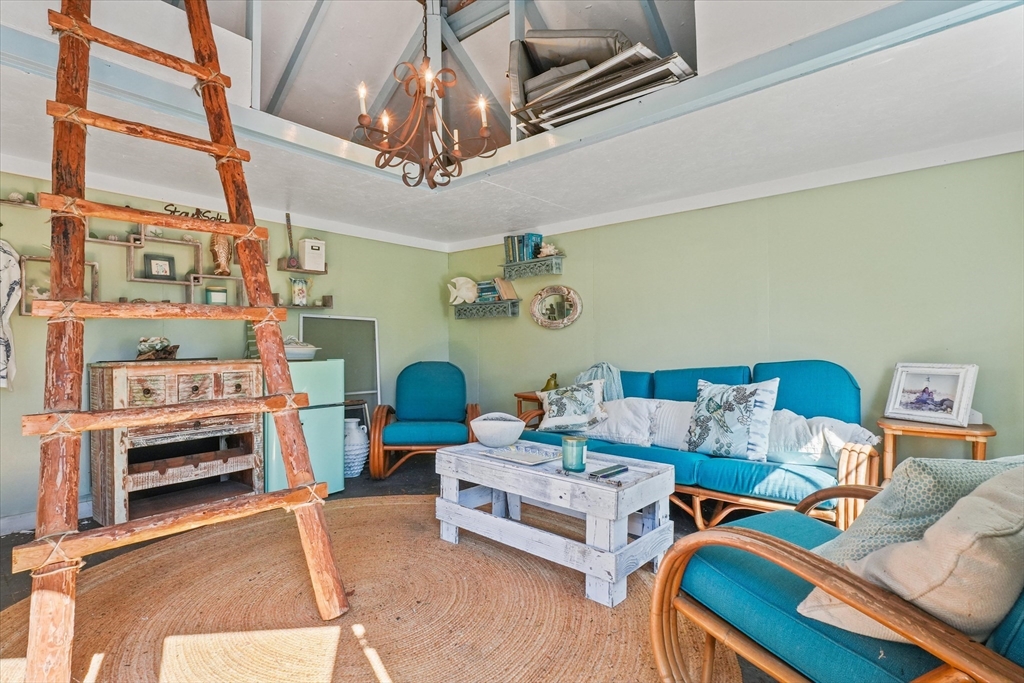 434 Main Street Amesbury, MA 01913 - Photo 33 of 40 a living room with furniture and a chandelier