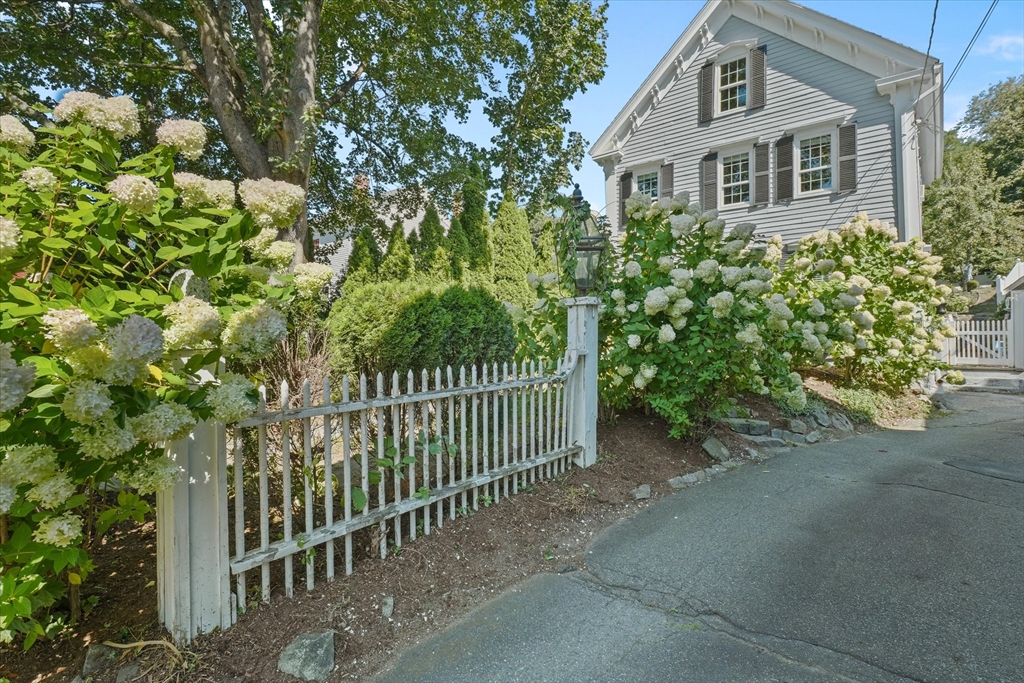 434 Main Street Amesbury, MA 01913 - Photo 34 of 40 a front view of a house with a garden