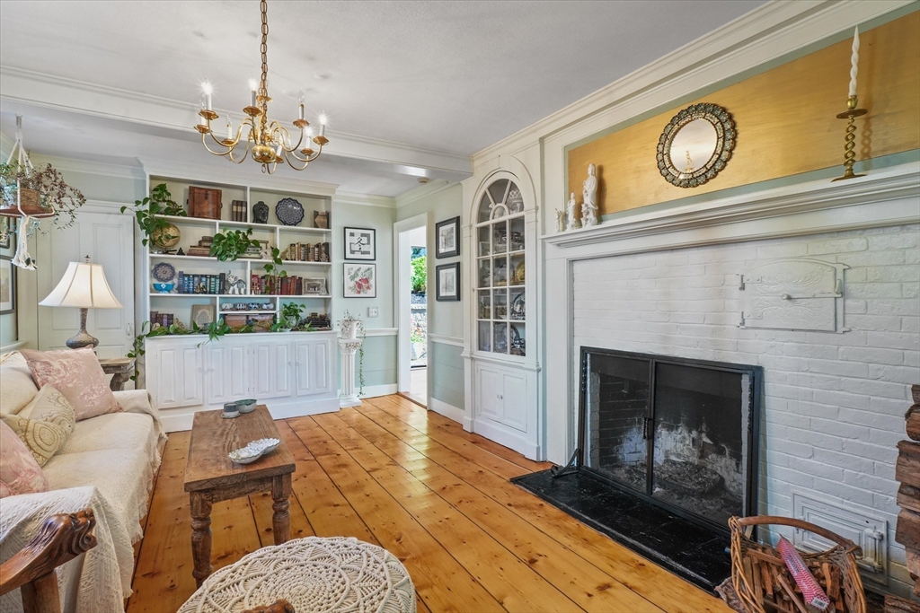 434 Main Street Amesbury, MA 01913 - Photo 5 of 40 a living room with furniture a chandelier and a fireplace