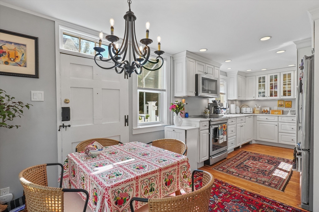 434 Main Street Amesbury, MA 01913 - Photo 7 of 40 a kitchen with a refrigerator sink cabinets and wooden floor