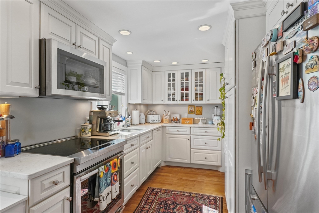 434 Main Street Amesbury, MA 01913 - Photo 8 of 40 a kitchen with a sink a stove and cabinets