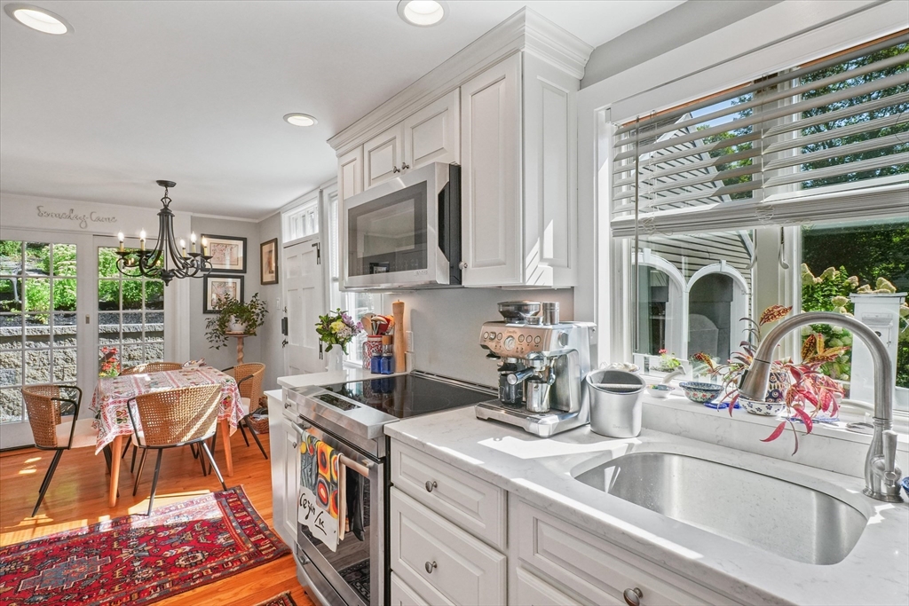 434 Main Street Amesbury, MA 01913 - Photo 9 of 40 a kitchen with stainless steel appliances granite countertop a sink and a stove top oven