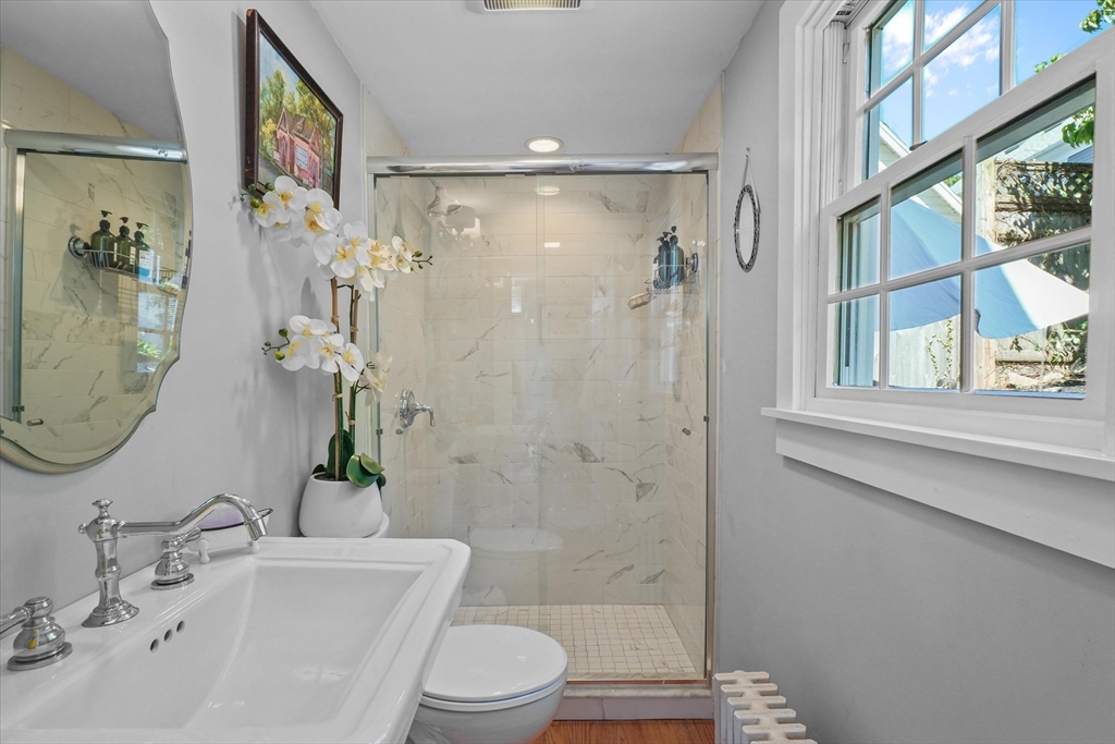 434 Main Street Amesbury, MA 01913 - Photo 10 of 40 a bathroom with a bathtub shower sink mirror and toilet