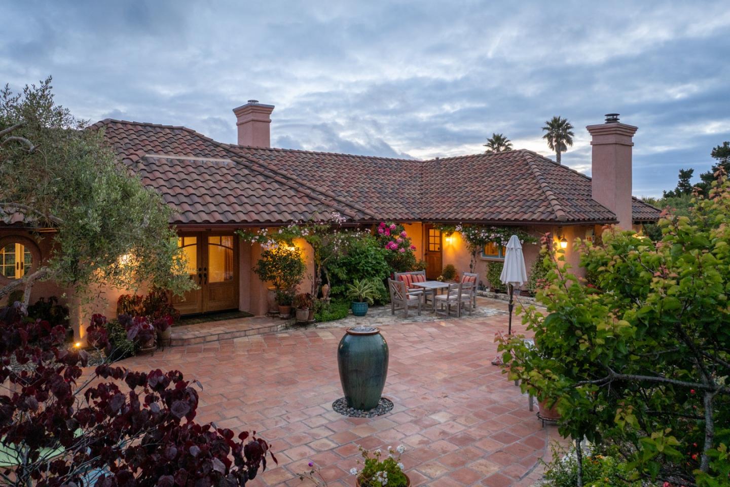 25987 Rio Vista Drive Carmel, CA 93923 - Photo 1 of 21 a view of a patio with table and chairs potted plants