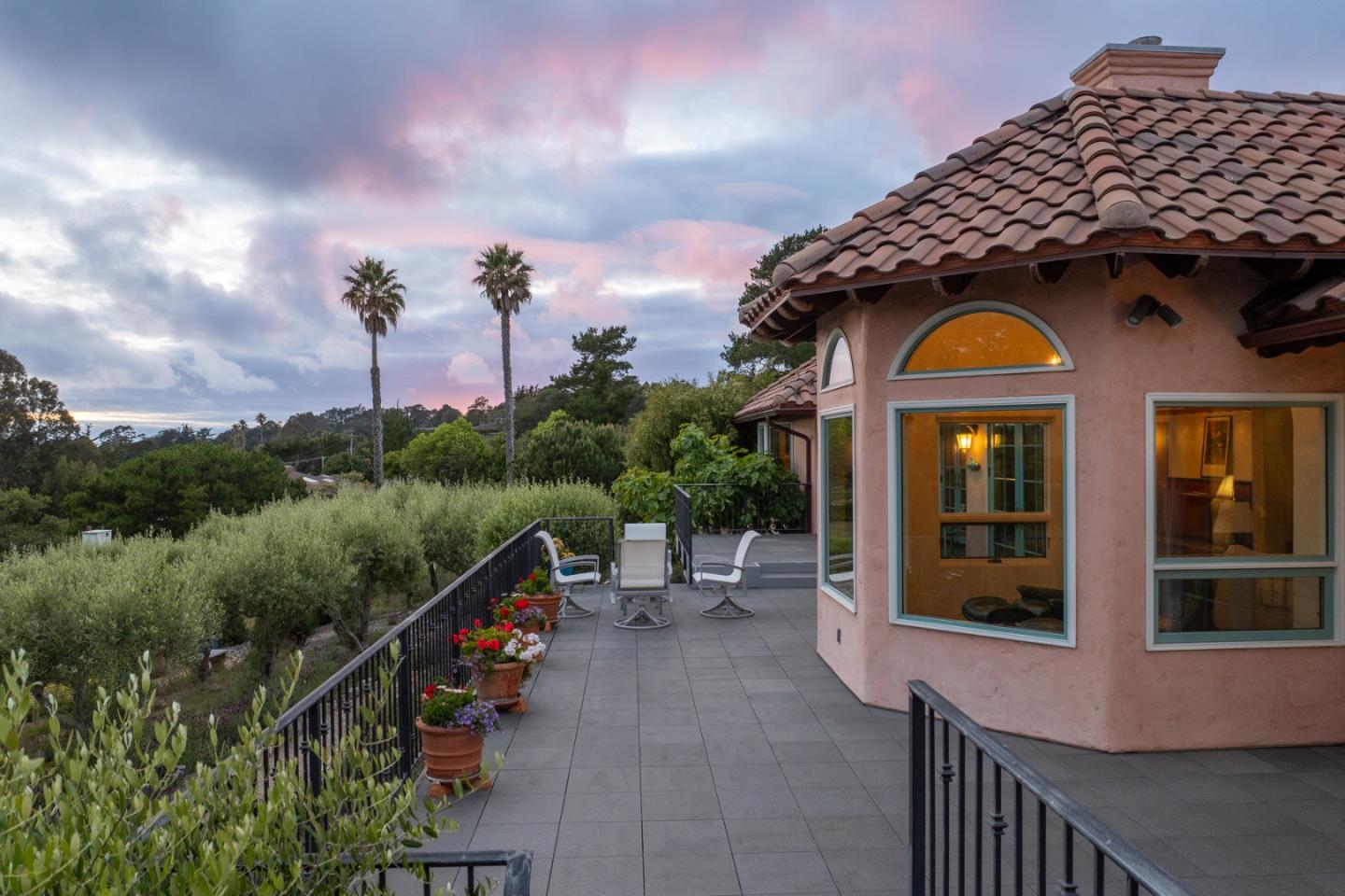 25987 Rio Vista Drive Carmel, CA 93923 - Photo 19 of 21 a view of a brick house with a large windows and a flower garden