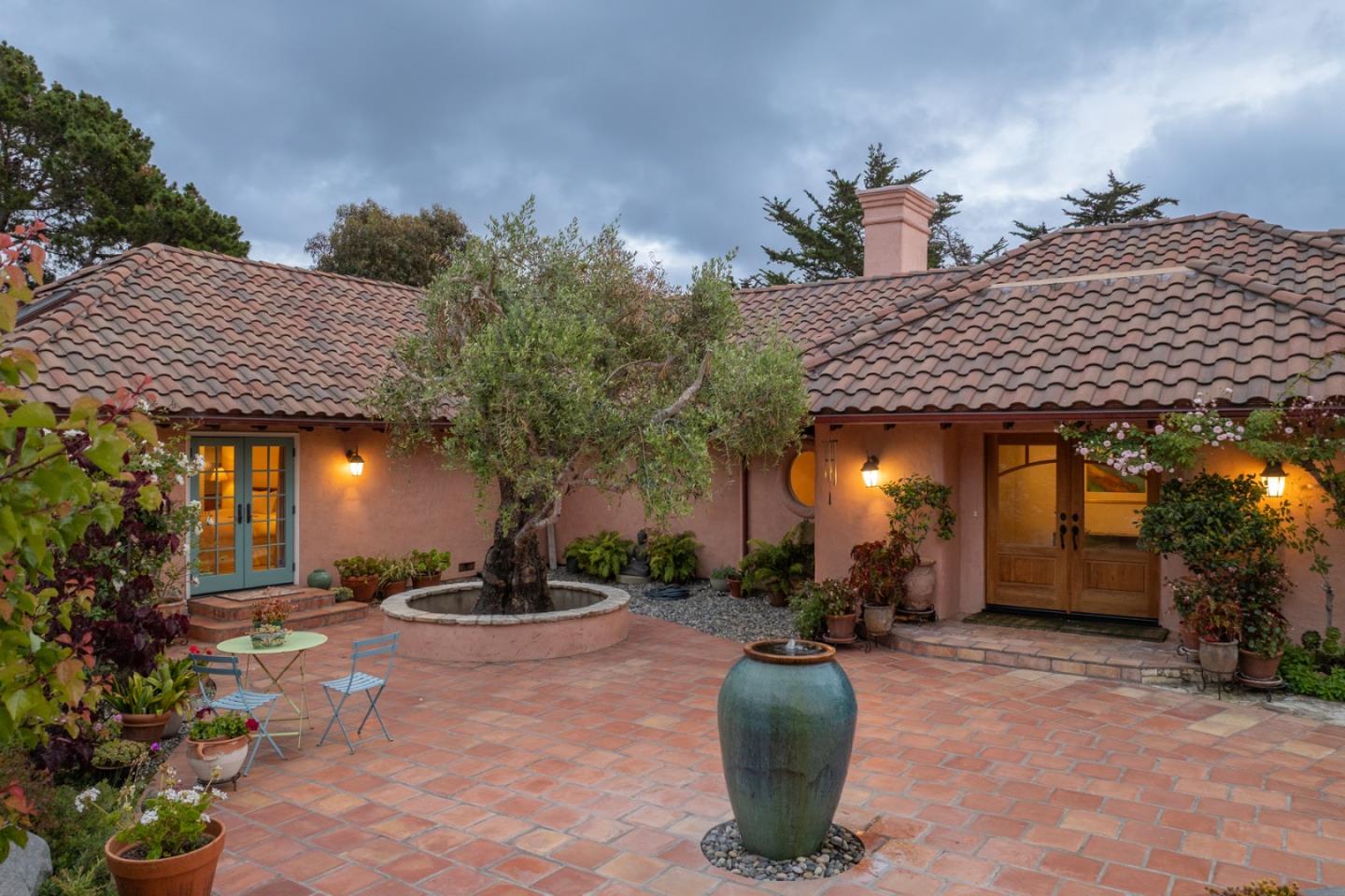 25987 Rio Vista Drive Carmel, CA 93923 - Photo 4 of 21 a view of a patio with table and chairs potted plants