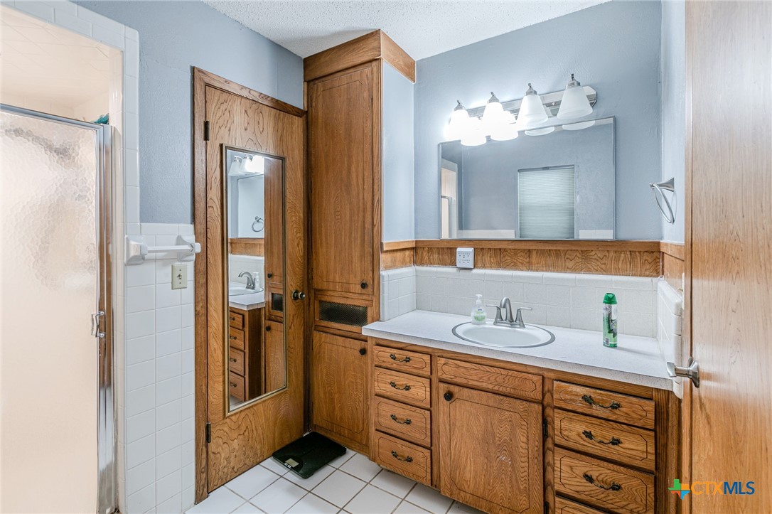 2411 Osage Road Gatesville, TX 76528 - Photo 12 of 26 Bathroom with vanity and storage