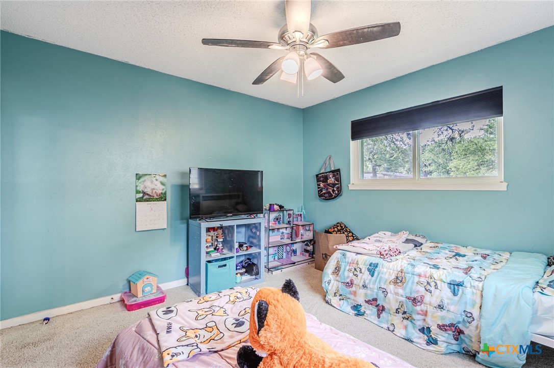 2411 Osage Road Gatesville, TX 76528 - Photo 14 of 26 Bedroom with ceiling fan and bright interior