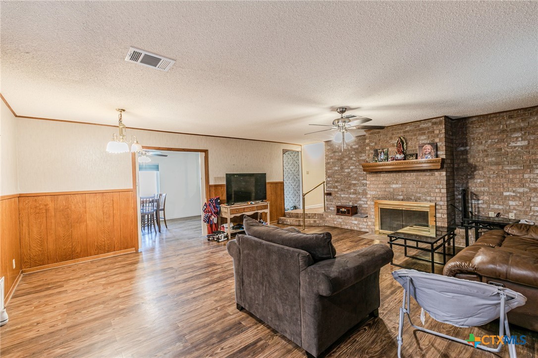 2411 Osage Road Gatesville, TX 76528 - Photo 4 of 26 Living room with wood flooring and stone fireplace