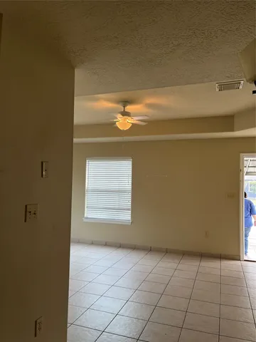 a view of a livingroom with an empty space and window