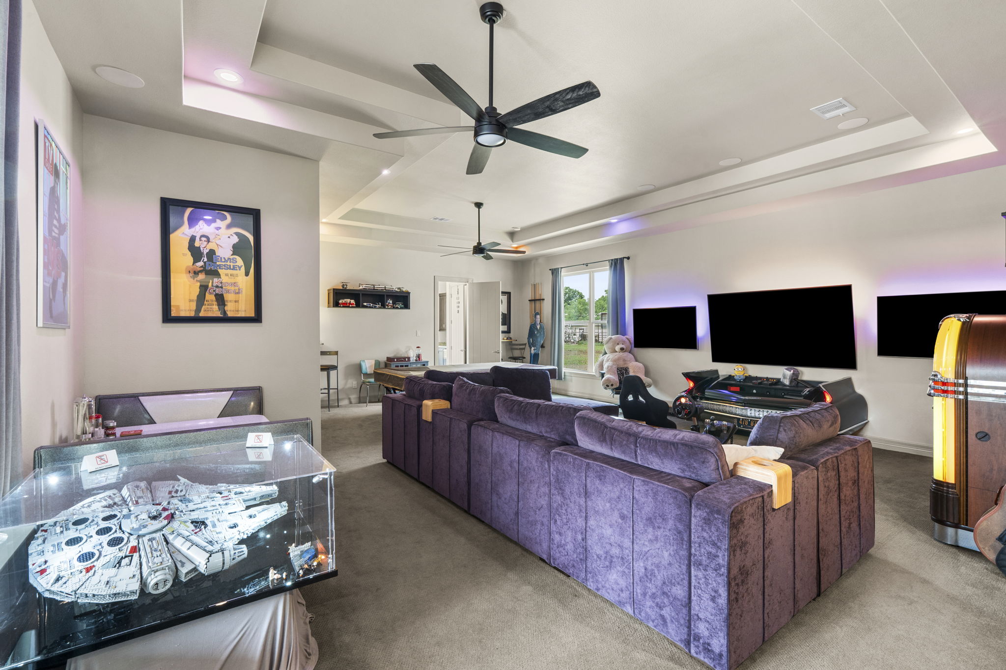 16202 Remuda Trail Buda, TX 78610 - Photo 22 of 40 Spacious living area featuring a tray ceiling, recessed lighting, and ceiling fans
