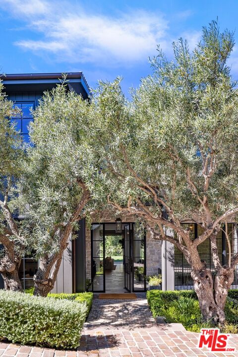 565 North Tigertail Road Los Angeles, CA 90049 - Photo 1 of 1 front view of a house with a yard