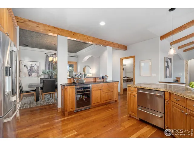 a kitchen with stainless steel appliances kitchen island granite countertop a stove a sink and a refrigerator