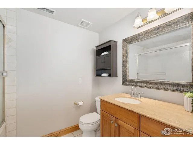a bathroom with a sink vanity granite and toilet