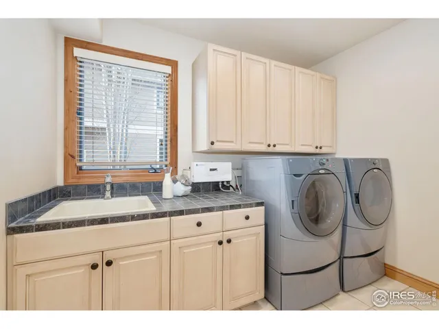 a kitchen with granite countertop a sink a stove and cabinets