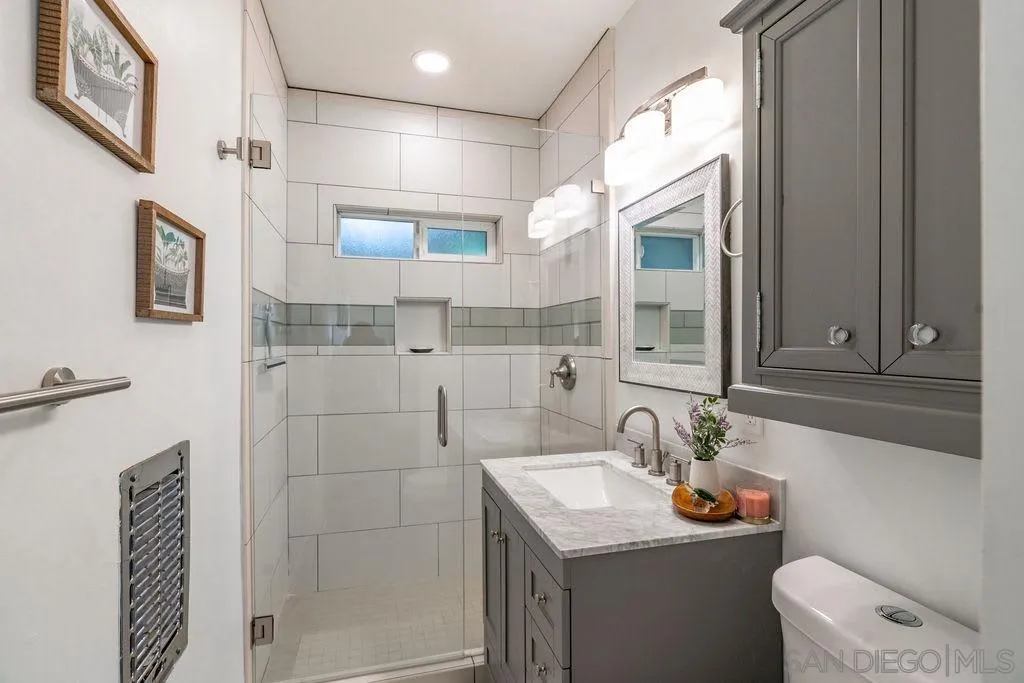 6529 Neptune Place La Jolla, CA 92037 - Photo 19 of 24 a bathroom with a sink toilet and shower