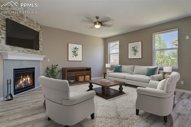 a living room with furniture a fireplace and a flat screen tv