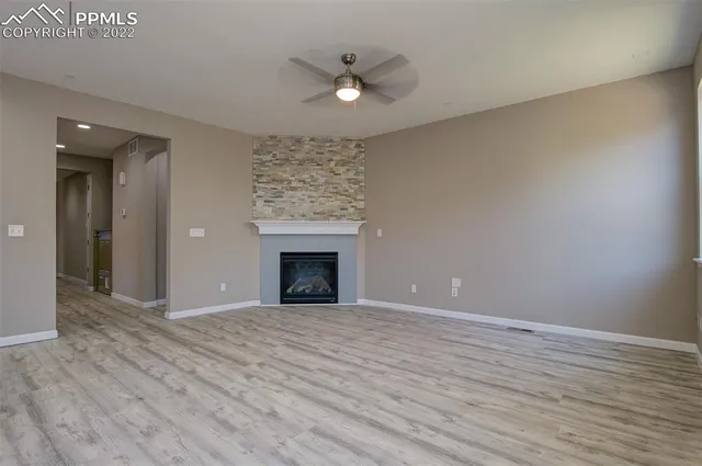 wooden floor in an empty room with a fireplace