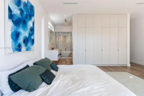 a bedroom with a bed and cupboard