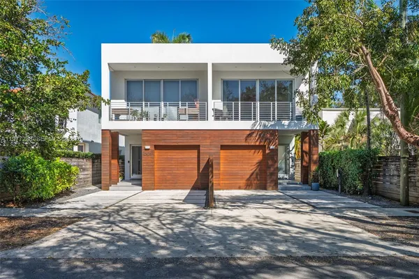 a view of house with outdoor space and balcony