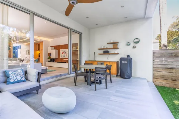 a living room with furniture a table and chairs