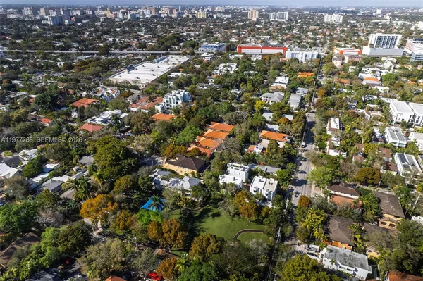 an aerial view of residential houses with city view