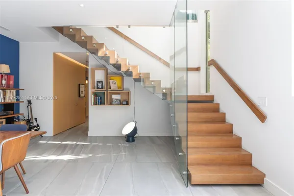 a view of entryway and hall with wooden floor