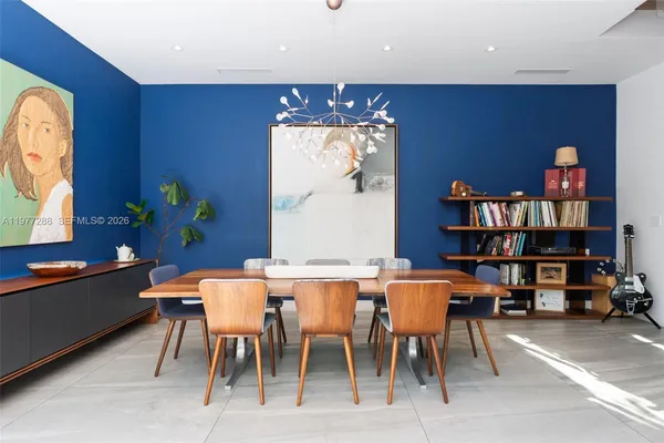 a view of a dining room with furniture and a chandelier