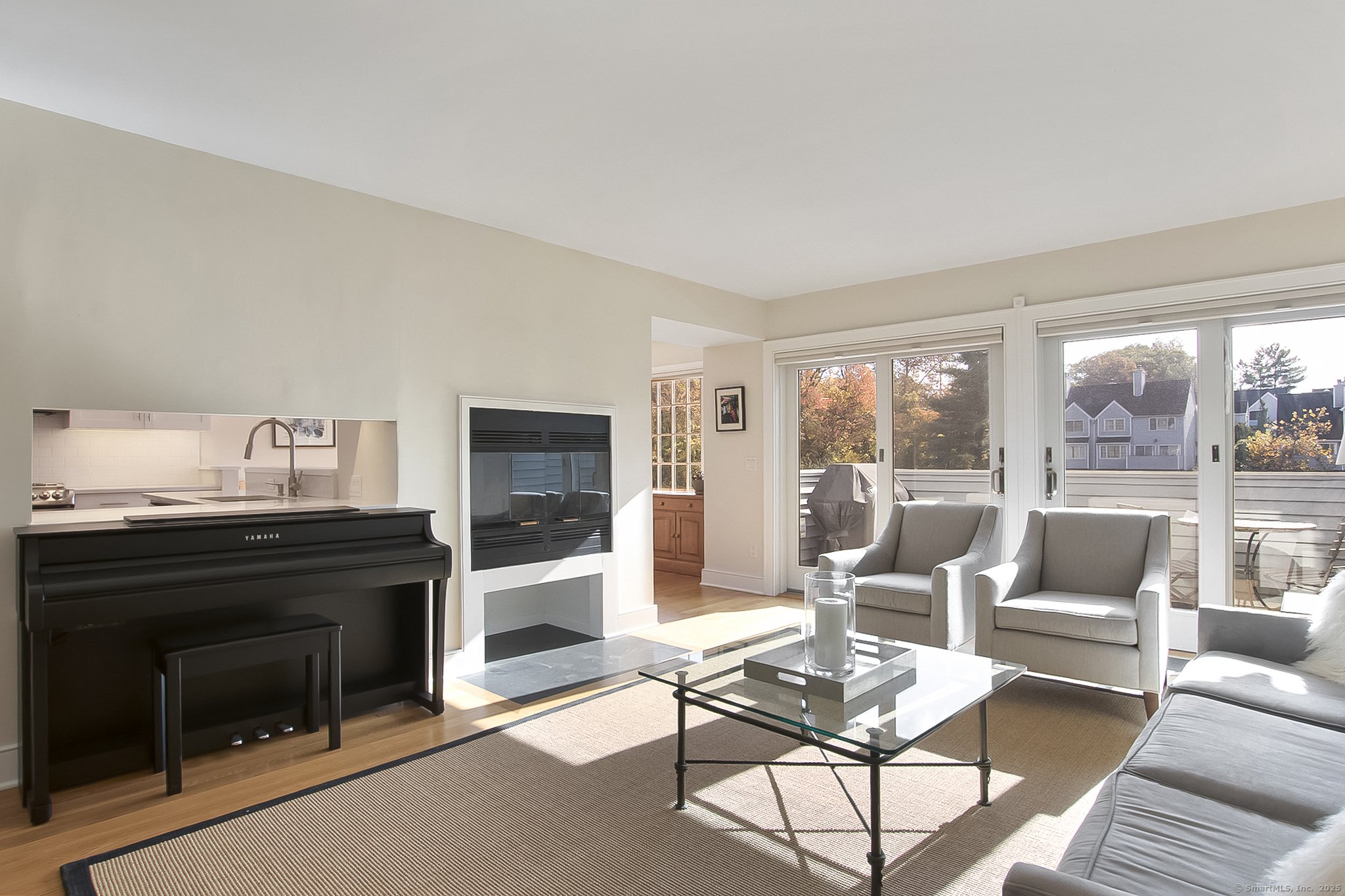 20 Wilton Crest, Unit 20 Wilton, CT 06897 - Photo 12 of 40 a living room with furniture a fireplace and a floor to ceiling window