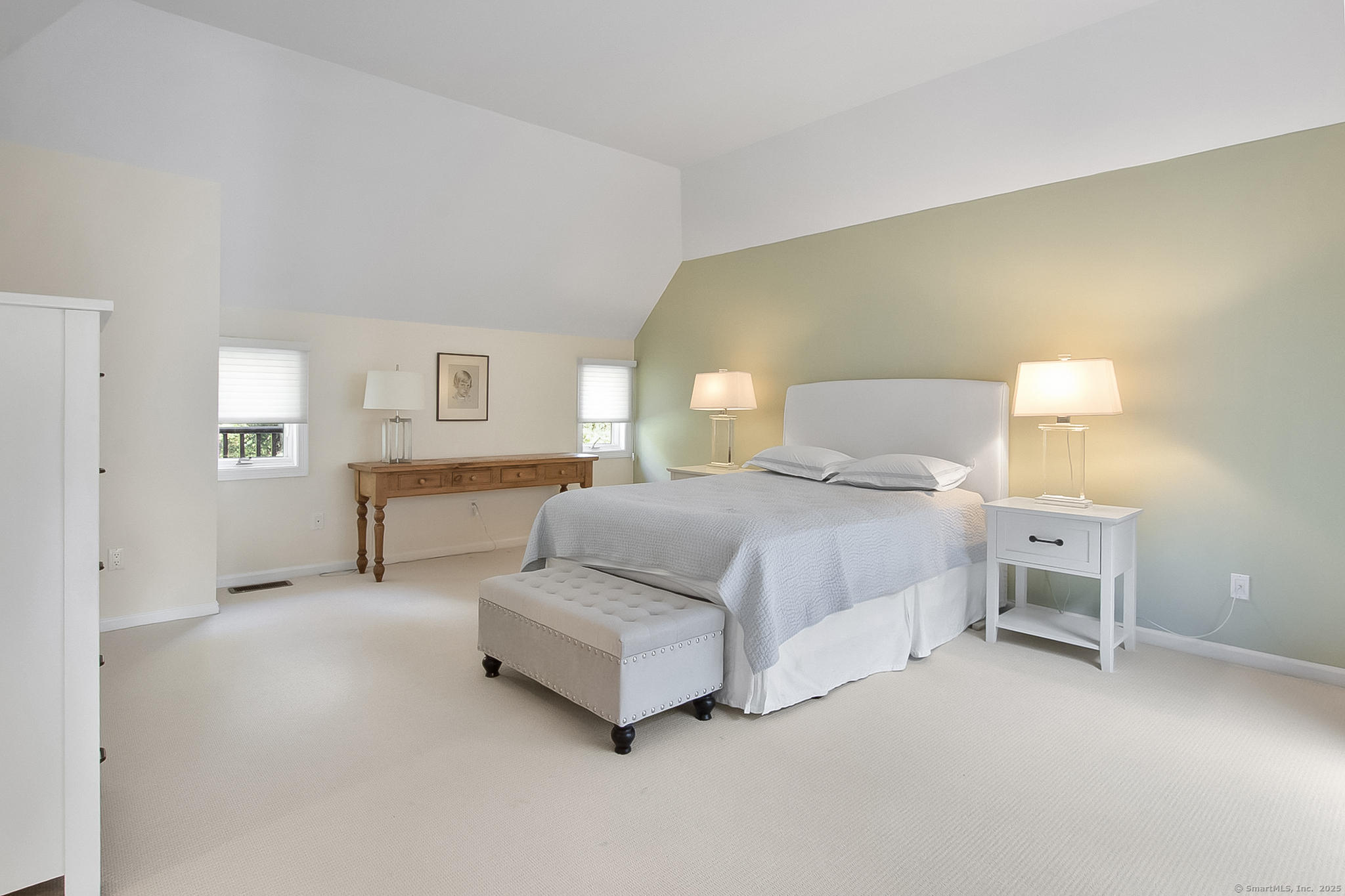 20 Wilton Crest, Unit 20 Wilton, CT 06897 - Photo 16 of 40 a spacious bedroom with a bed and a lamp