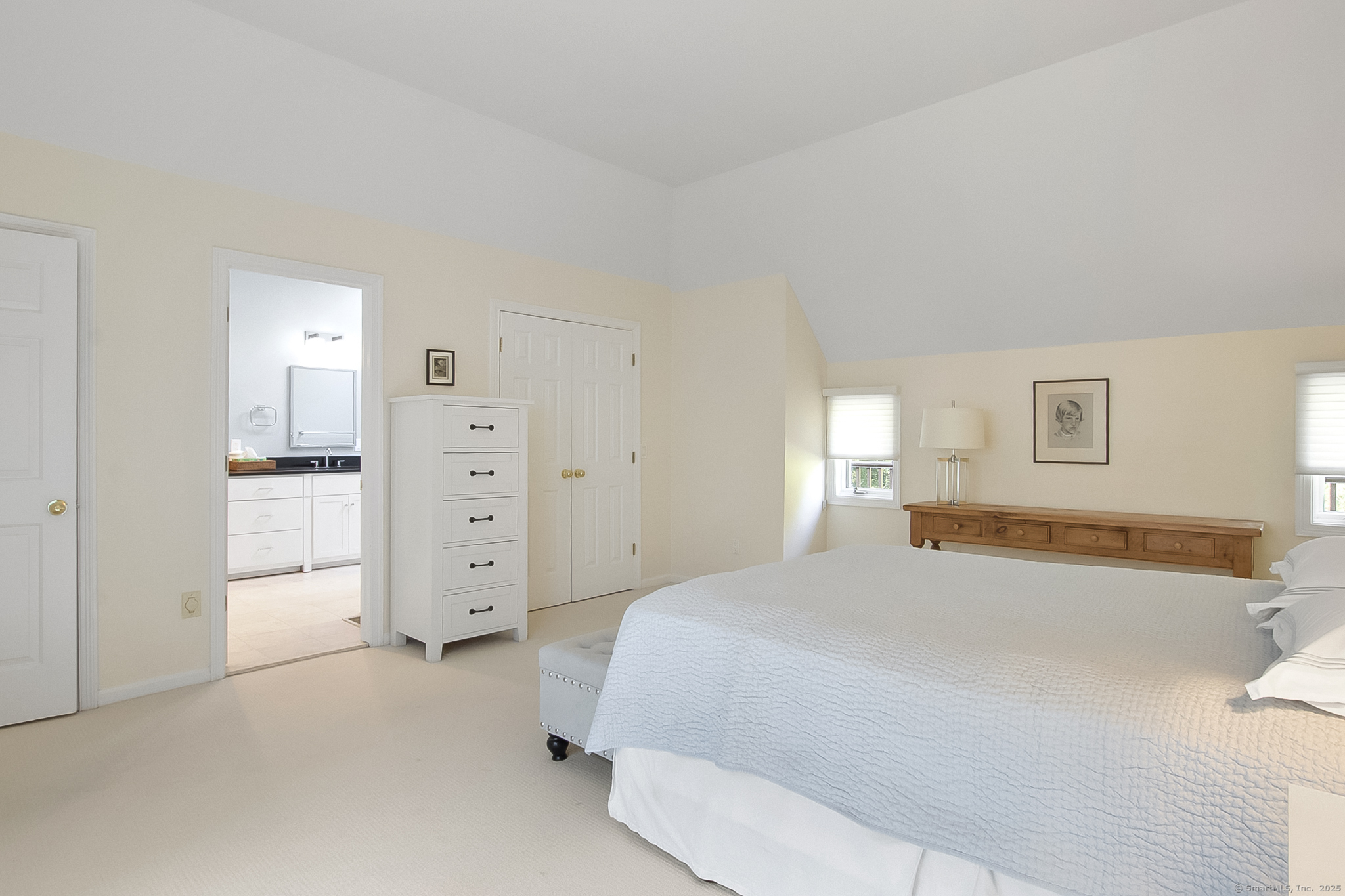 20 Wilton Crest, Unit 20 Wilton, CT 06897 - Photo 20 of 40 a spacious bedroom with a bed and cabinets