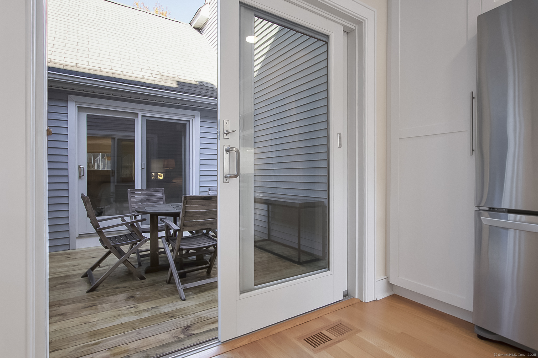 20 Wilton Crest, Unit 20 Wilton, CT 06897 - Photo 30 of 40 a view of a hallway with a dining room and wooden floor